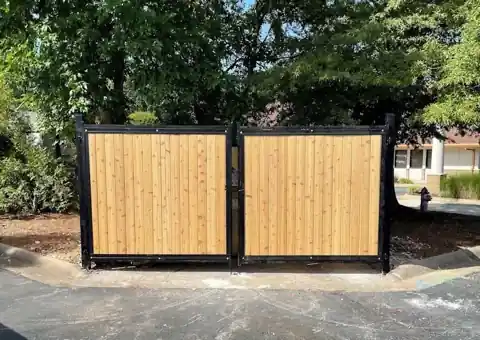 Dumpster enclosure with cedar in black steel frames and double gates, Fayetteville