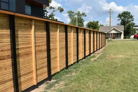 Cedar privacy fence set on black steel posts