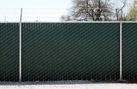 Chain link fence with green privacy slats